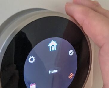 smart-home-thermostat-technology-with-hand-2022-11-14-06-40-22-utc