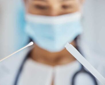 Covid, health and medical test with swab for nose or throat, doctor and mask for safety at hospital.