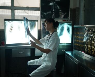 Doctor looking at x-ray image. Female medical doctor looking at x-rays in a hospital. Healthcare surgery diagnosis concept